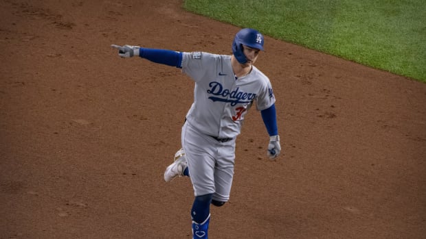 Oct 25, 2020; Arlington, Texas, USA; Los Angeles Dodgers left fielder Joc Pederson (31) hits a home run against the Tampa Bay Rays during the second inning in game five of the 2020 World Series at Globe Life Field. Mandatory Credit: Jerome Miron-USA TODAY Sports